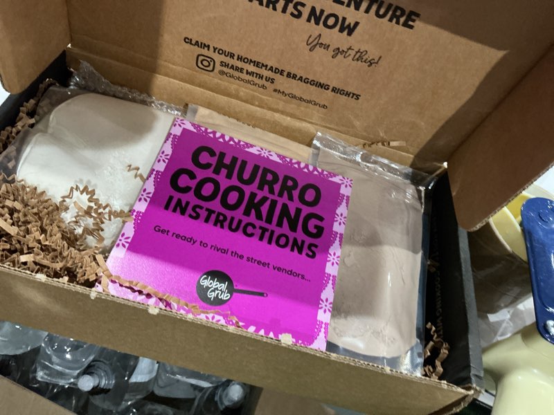 Condition photo showing As Is for (expired)global grub diy churro kit - homemade churro kit includes churro mix, cinnamon sugar, chocolate dipping mix, churro piping set, cooking instructions. makes 40 churros. great gift for churro lovers!
