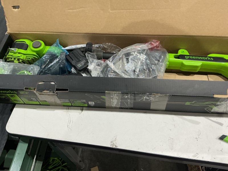 Condition photo showing As Is for greenworks 24v 12" cordless string trimmer/edger (includes 20 blades), 4.0ah battery and charger included