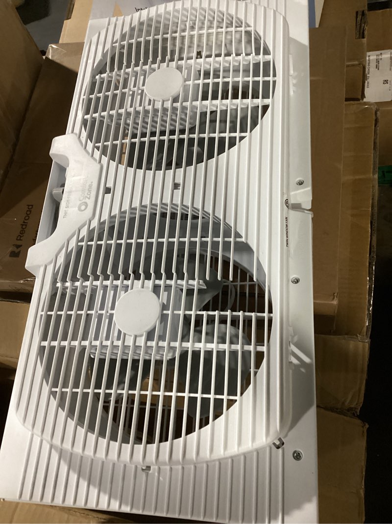 Condition photo showing As Is for comfort zone 9  twin window fan with reversible airflow control  auto-locking expanders  2 speed fan  dual fan  exhaust  airflow 9.84 ft/sec  ideal for home  kitchen  bedroom & office  cz319wt