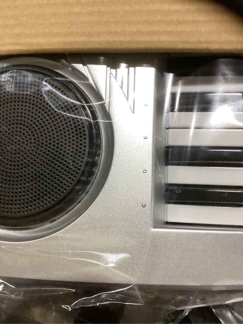 Condition photo showing Good Condition for Raimy Piano Keyboard for Beginners, 61 Keys Portable Electronic Digital Piano with Microphone, Learning Educational Music Keyboard Piano for Kids Gifts Toys for Boys Girls Toddlers (Silver) Sliver