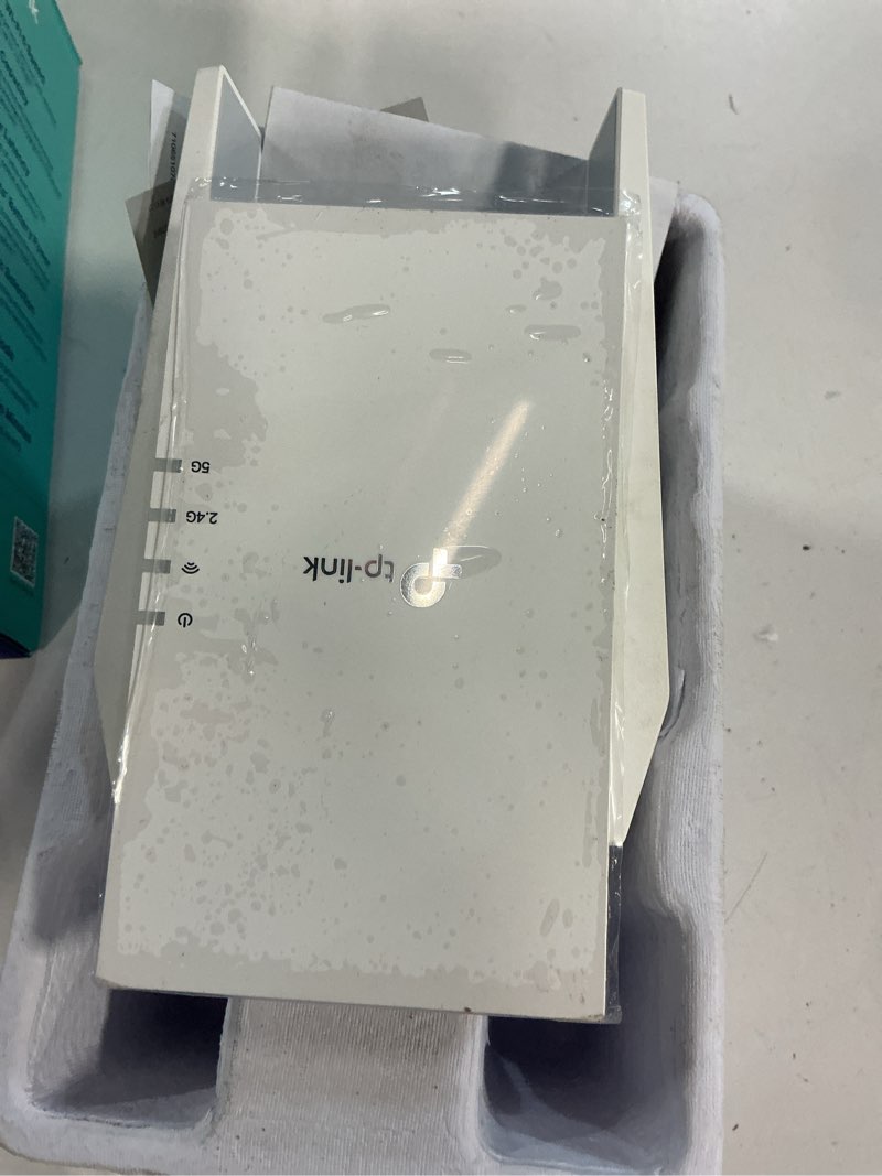 Condition photo showing As Is for tp-link ax1500 wi-fi 6 dual-band  range extender with quick 1.5 gbps transfer rate  smart roaming for steady wireless coverage and also connect a device through the ethernet port - re1500x