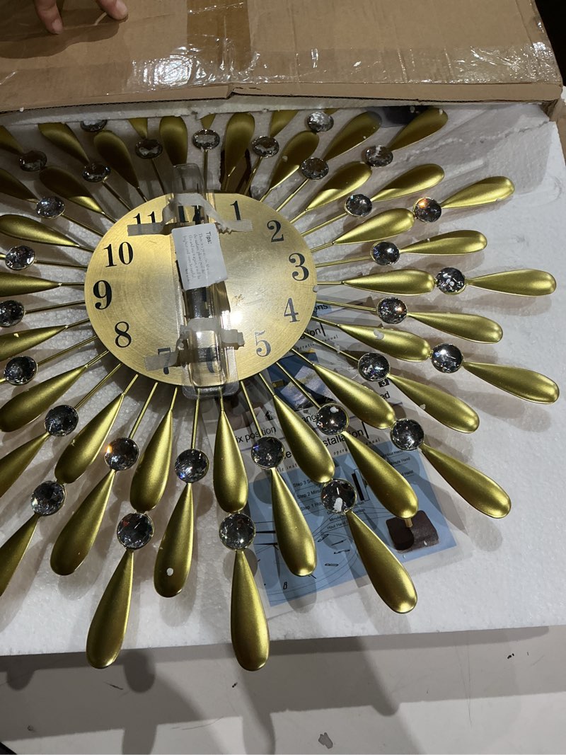 Condition photo showing Good Condition for 24 INCH Gold Large Wall Clock for Living Room Decor,Non-Ticking Quiet Metal Petals Dial Glass Big Wall Clocks Black for Bedroom,bedrooms Kitchen and Small Space Decoration Gold 19.7 Inch