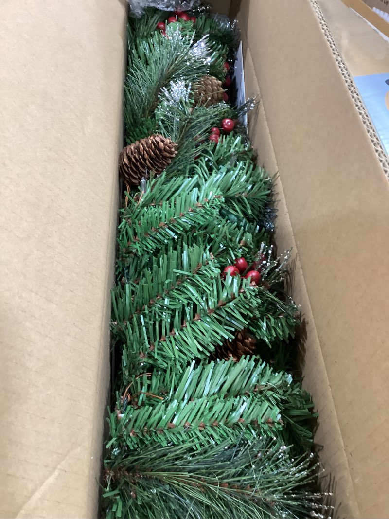 Condition photo showing Good Condition for national tree company 9 ft pre-lit crestwood spruce artificial christmas garland, christmas decoration with glitter, pinecones, red berries, 50 clear lights, 180 tips, green plug in tree