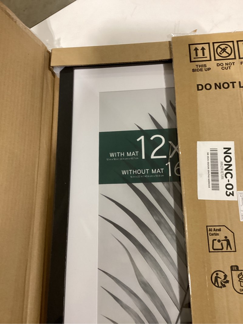 Condition photo showing New/Like New for mcs studio gallery 16x22 matted poster frame with 12x18 picture display, black woodgrain engineered wood vertical & horizontal wall hanging large picture frame for photos, posters & art prints (1-pack) 1-pack black woodgrain 12x18