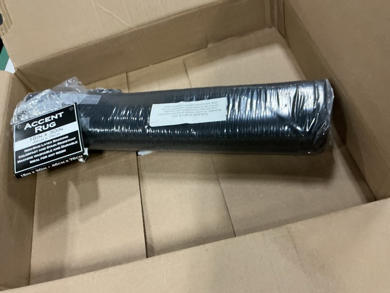 Condition photo showing New/Like New for ritz solid accent rug: 18" x 30" stain resistant kitchen or living room floor mat, latex backing, machine washable, black black 1'6" x 2'6" (rectangular)