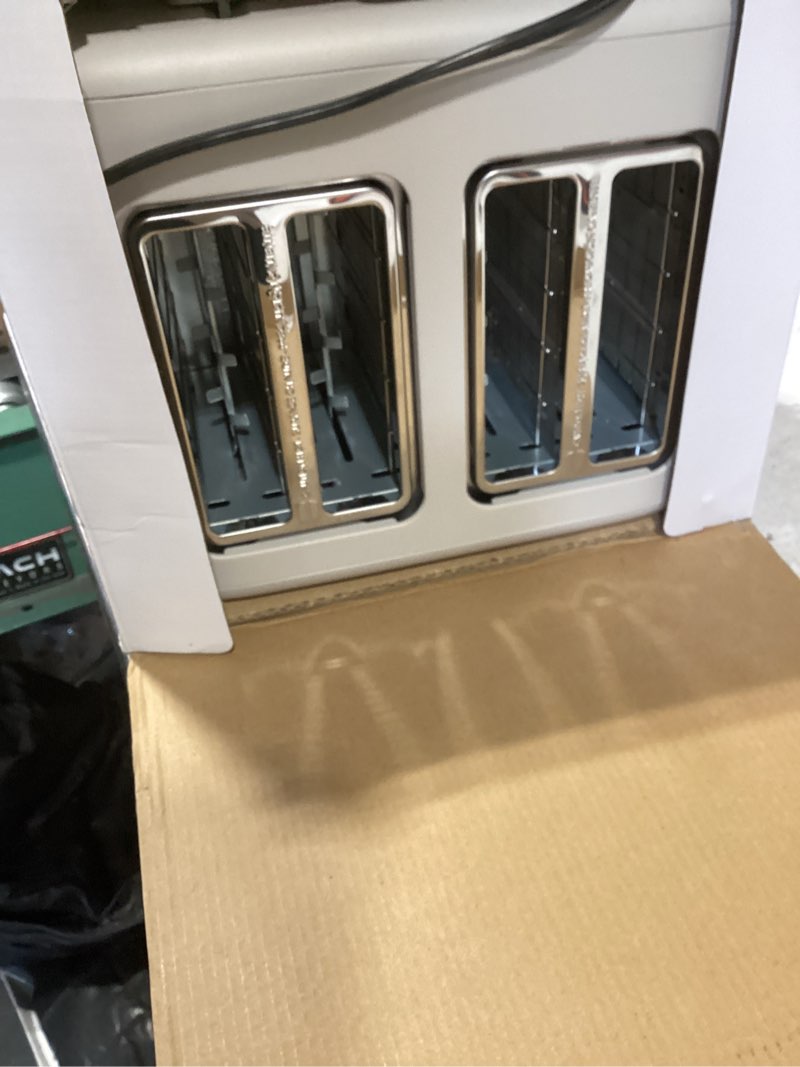 Condition photo showing New/Like New for bella 4 slice toaster, 6 setting shade control with reheat & cancel buttons, removable crumb tray, anti jam & auto shutoff, 900 watt, oatmilk