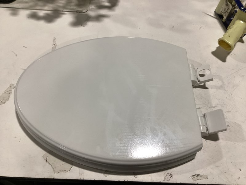 Condition photo showing As Is for american standard moments wood white elongated soft close toilet seat
