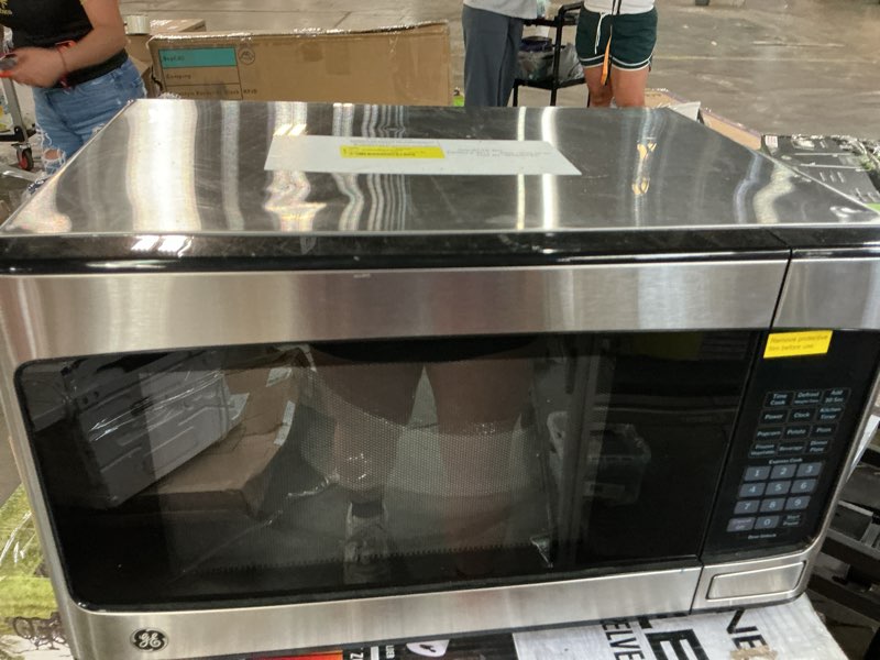Condition photo showing As Is for ge 1.1 cu ft countertop microwave oven stainless steel