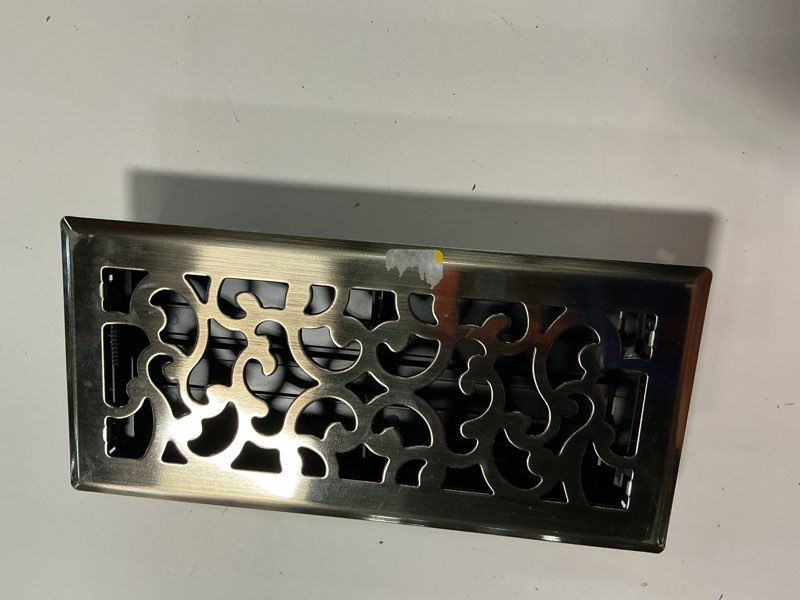 Condition photo showing As Is for allen + roth 4-in x 10-in maximum airflow steel antique brass savannah design floor register