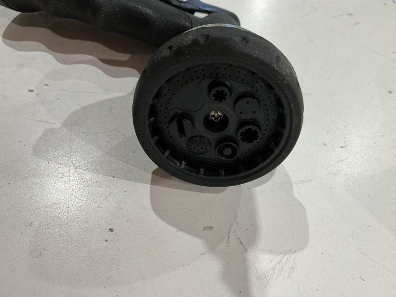 Condition photo showing As Is for garden hose nozzle, abs water spray nozzle with heavy duty 7 adjustable watering patterns, slip for plants, lawn, washing cars, cleaning, showering pets & outdoor fun