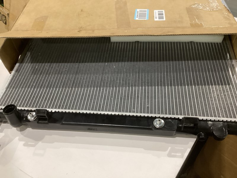 Condition photo showing As Is for spectra premium cu2370 radiator with toc and eoc, not exact, similar to stock photo