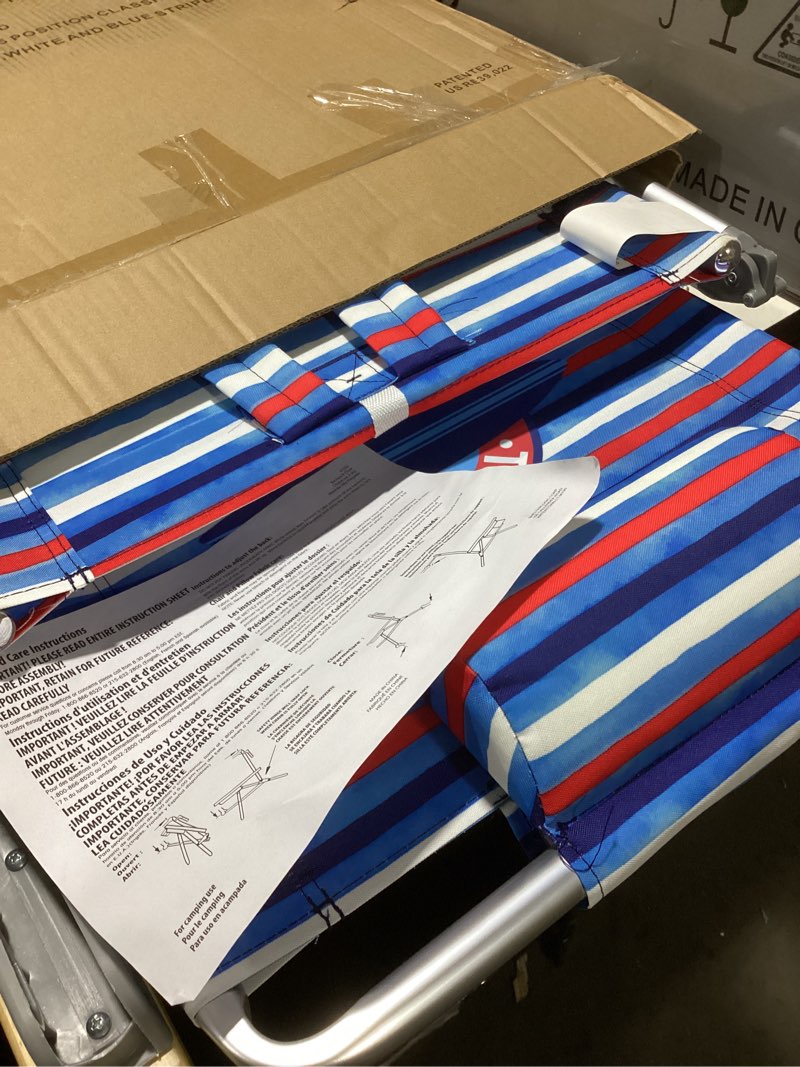 Condition photo showing As Is for tommy bahama 5-position classic lay flat folding backpack beach chair, aluminum, red, white, and blue stripe red, white, and blue stripe 1-pack