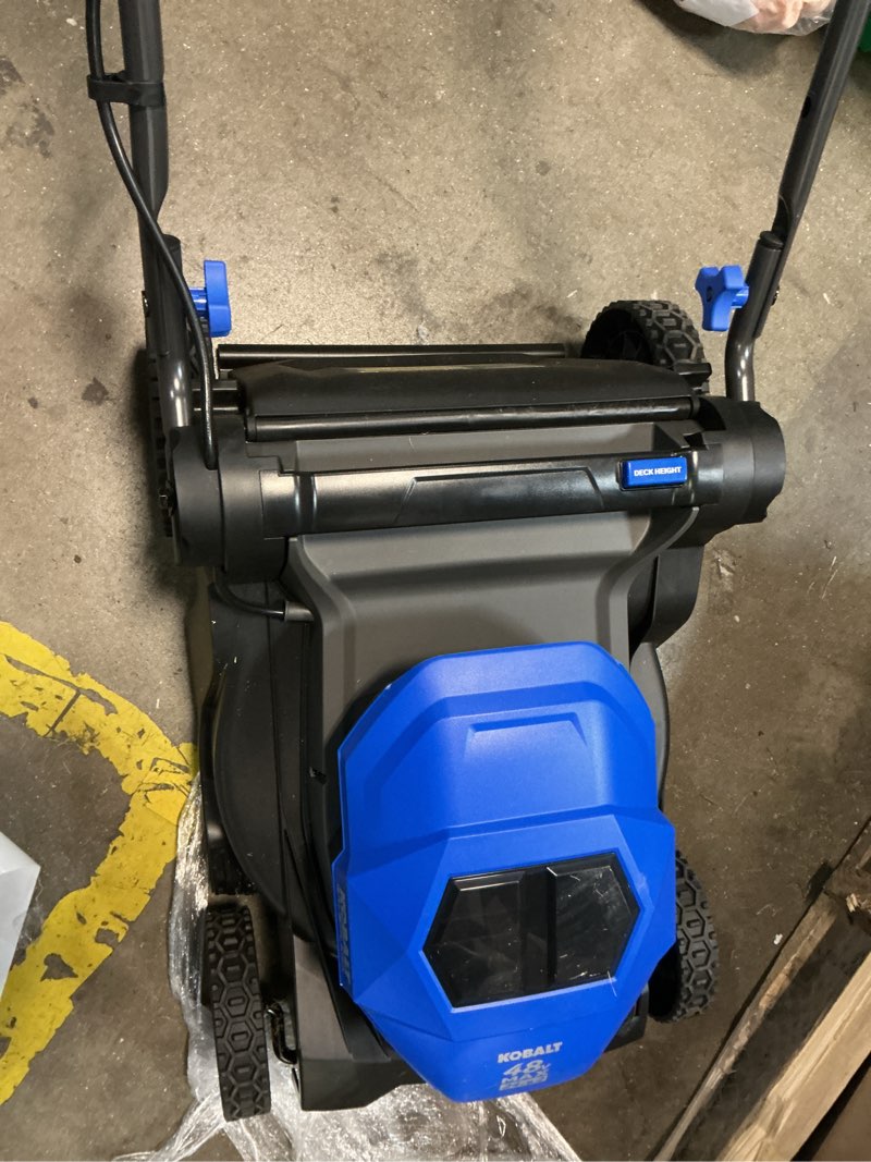 Condition photo showing As Is for kobalt 48v max (24vx2) 21-in self-propelled mower kit, (2) 6.0ah batteries and charger included