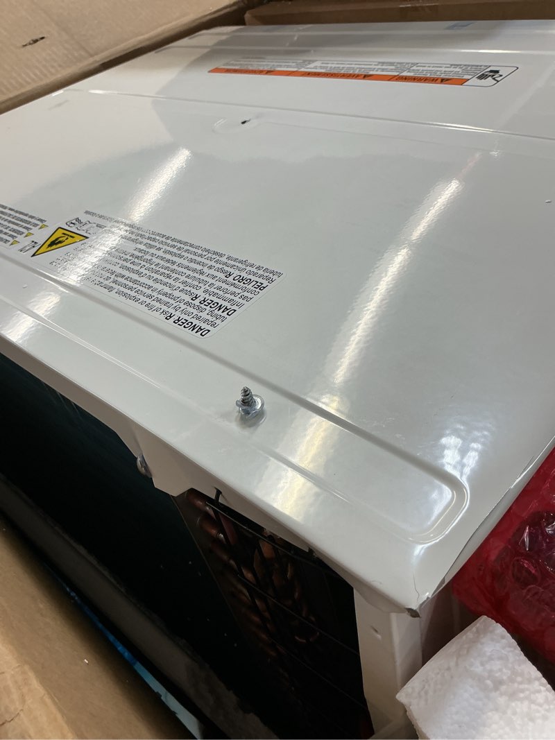 Condition photo showing As Is for (demagned )whirlpool 10,000 btu through the wall air conditioner, 115v, cools up to 450 sq. ft. for living room, bedroom, kitchen with dehumidifier and remote control, white