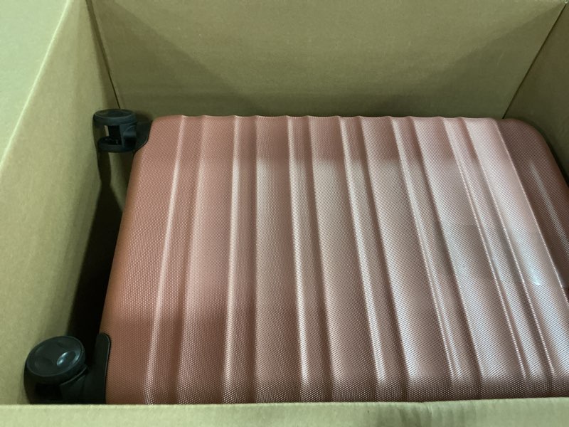 Condition photo showing As Is for Amazon Basics 26" Hardside Medium Checked Luggage, Hardshell Suitcase With Wheels, Expandable For Up to 15% More Space, With Scratch-Resistant Surface, Four Multi-directional Wheels, Rose Gold Rose Gold Medium Checked