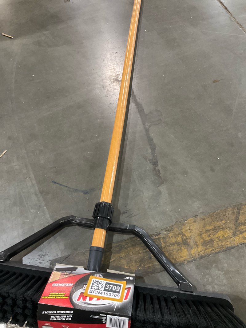 Condition photo showing As Is for 24 in. high power smooth surface industrial grade push broom with 60 in. wood handle and brace