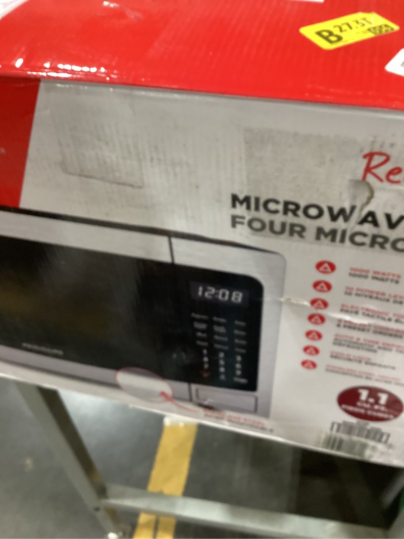 Condition photo showing As Is for RCA RMW1178 1.1 Cu Ft Stainless Steel Countertop Microwave Oven, Multi Function, Programmable, 1000W, residential kitchen, Stainless