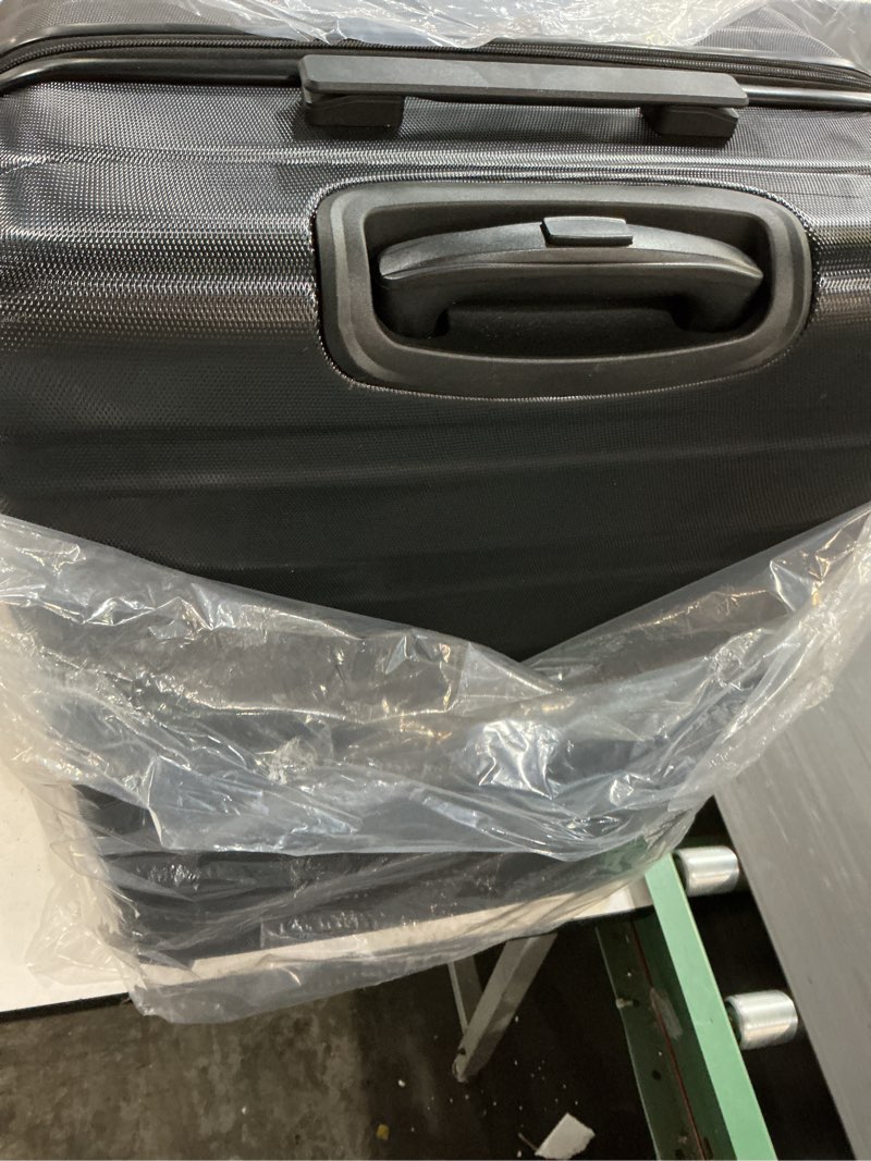 Condition photo showing New/Like New for amazon basics 30" hardside large checked luggage, hardshell suitcase with four multi-directional wheels, expandable for up to 15% more space, scratch-resistant shell, black black large checked