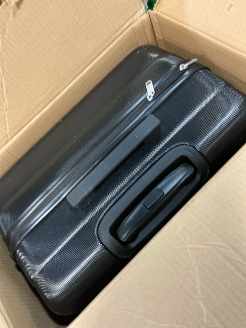 Condition photo showing As Is for amazon basics 30" hardside large checked luggage, hardshell suitcase with four multi-directional wheels, expandable for up to 15% more space, scratch-resistant shell, black black large checked