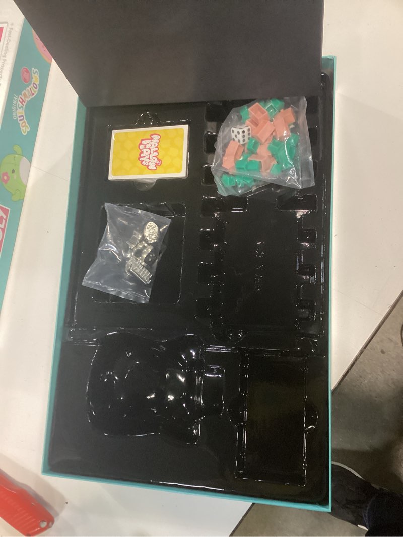 Condition photo showing As Is for monopoly: squishmallows | collector’s edition featuring cam the cat plush buy, sell, trade spaces squshmallows collectible classic monopoly game officially-licensed for 6 players