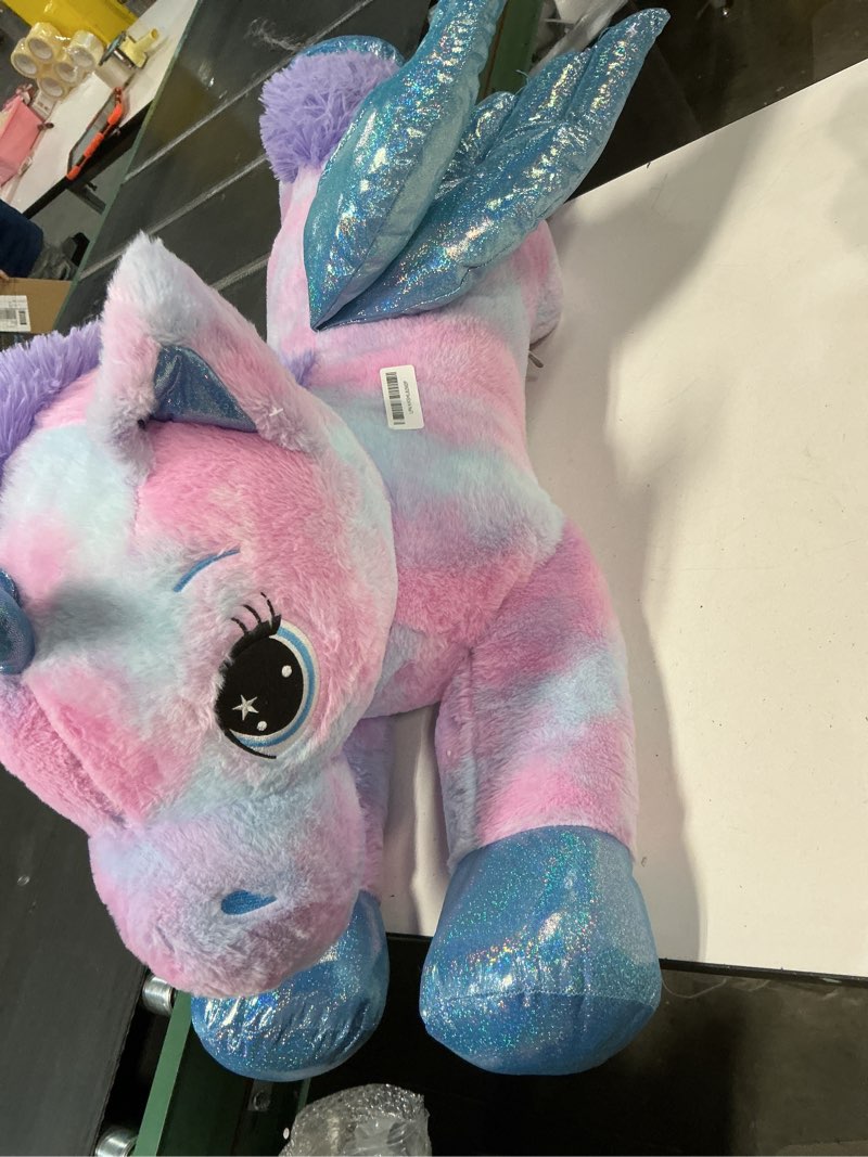 Condition photo showing Good Condition for Tezituor 43 Inch Rainbow Purple Unicorn Stuffed Animal with Wings, Giant Stuffed Unicorn Plush Toys for Girls Kids Boys Women,Soft Plushie Gifts for Valentines Day,Christmas, Birthday Party Rainbow Unicorn with Wings