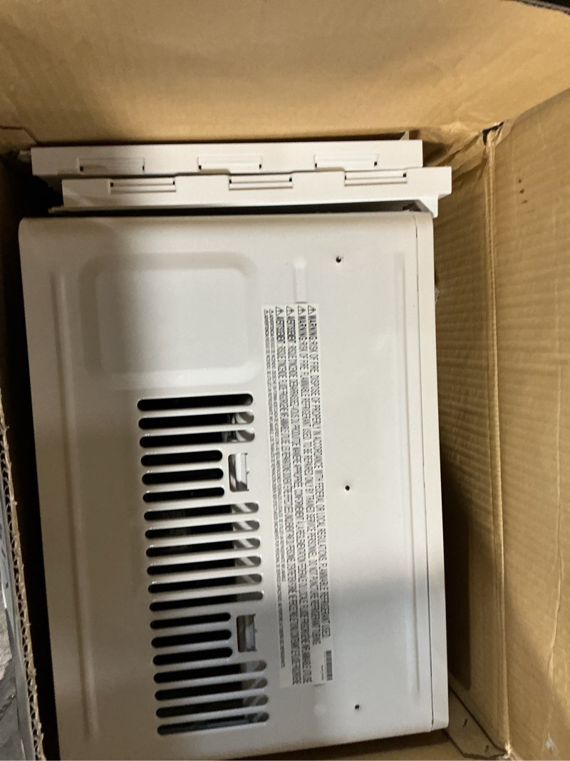 Condition photo showing As Is for 5,000 btu 115-volt window air conditioner 150 sq. ft. rooms with remote in white