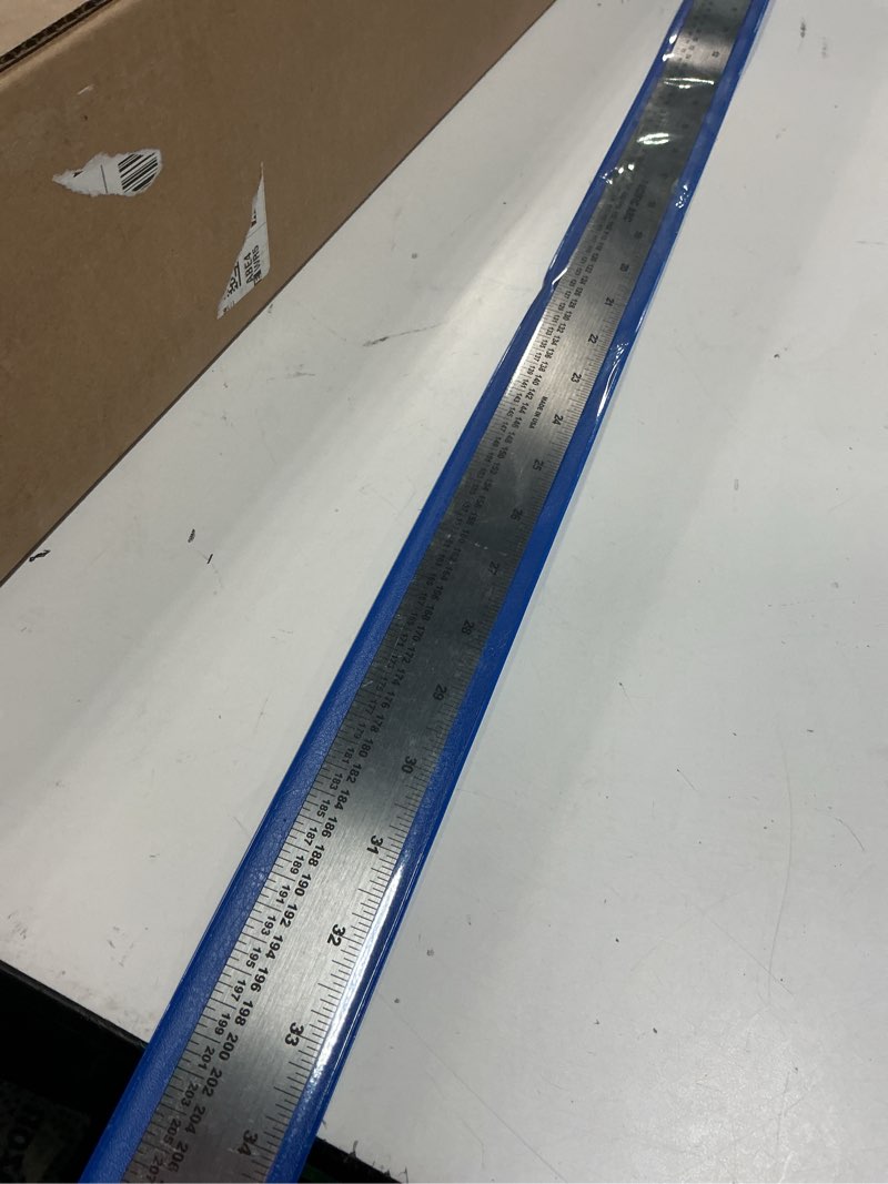 Condition photo showing Good Condition for pacific arc, stainless steel ruler with inch and pica measurements, 36 inches, rubber backed