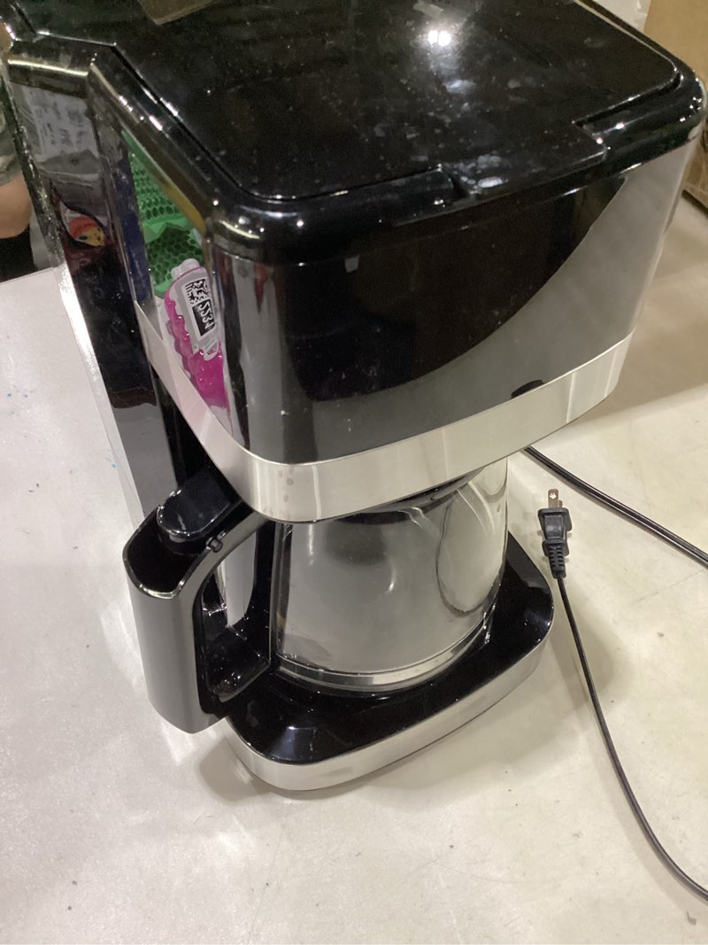 Condition photo showing As Is for amazon basics 12 cup drip coffee maker, coffee machine with glass coffee pot (1.9 qt), auto shut-off, auto pause, removable filter basket, black & silver 12-cup non-programmable - new model