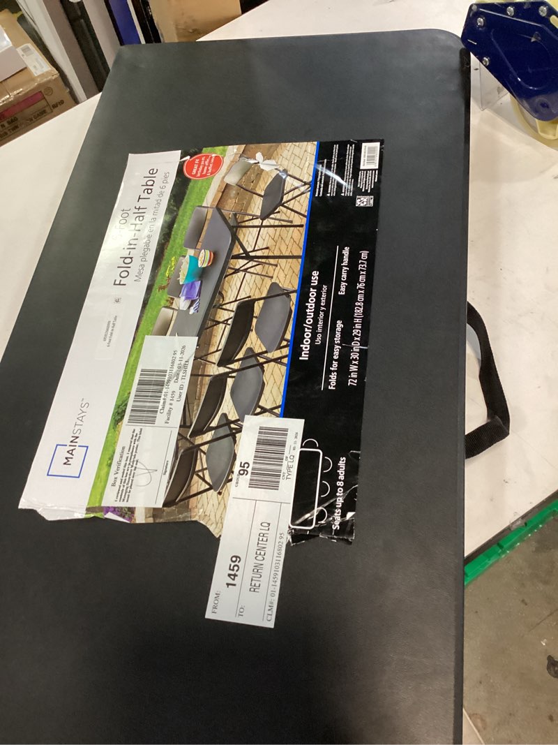 Condition photo showing As Is for mainstays 6 foot centerfold folding table, black broken