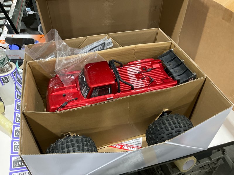Condition photo showing As Is for arrma rc truck outcast 4x4 4s blx 1/10th 4wd stunt truck rtr (battery and charger not included), red, ara4410v2t4