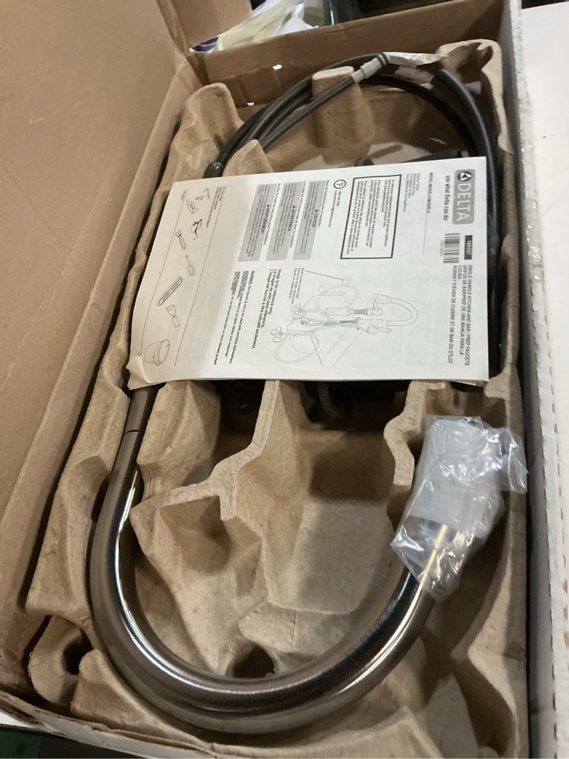 Condition photo showing As Is for delta essa brushed nickel kitchen faucet with pull down sprayer, modern single hole kitchen sink faucet, single handle, arctic stainless 9113-ar-dst