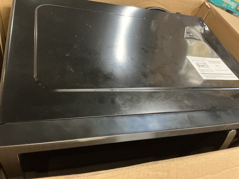 Condition photo showing As Is for farberware 1.1 cu. ft. countertop microwave oven – 1000 watts power, auto cook settings, defrost, easy clean and child safety lock - stainless 1.1 cu. ft. stainless steel