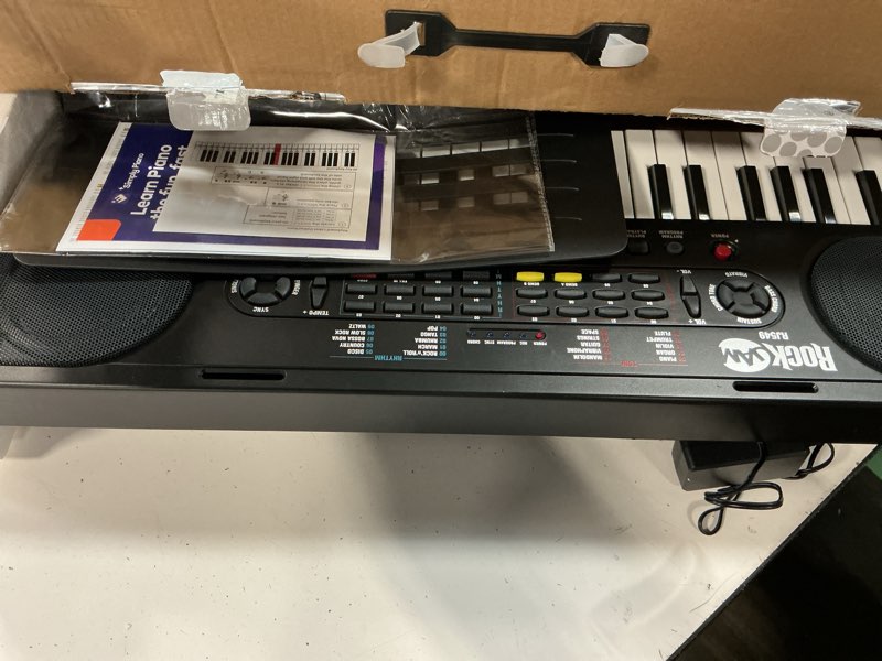 Condition photo showing As Is for rockjam 49 key keyboard piano,sheet music stand, piano note stickers & simply piano lessons black