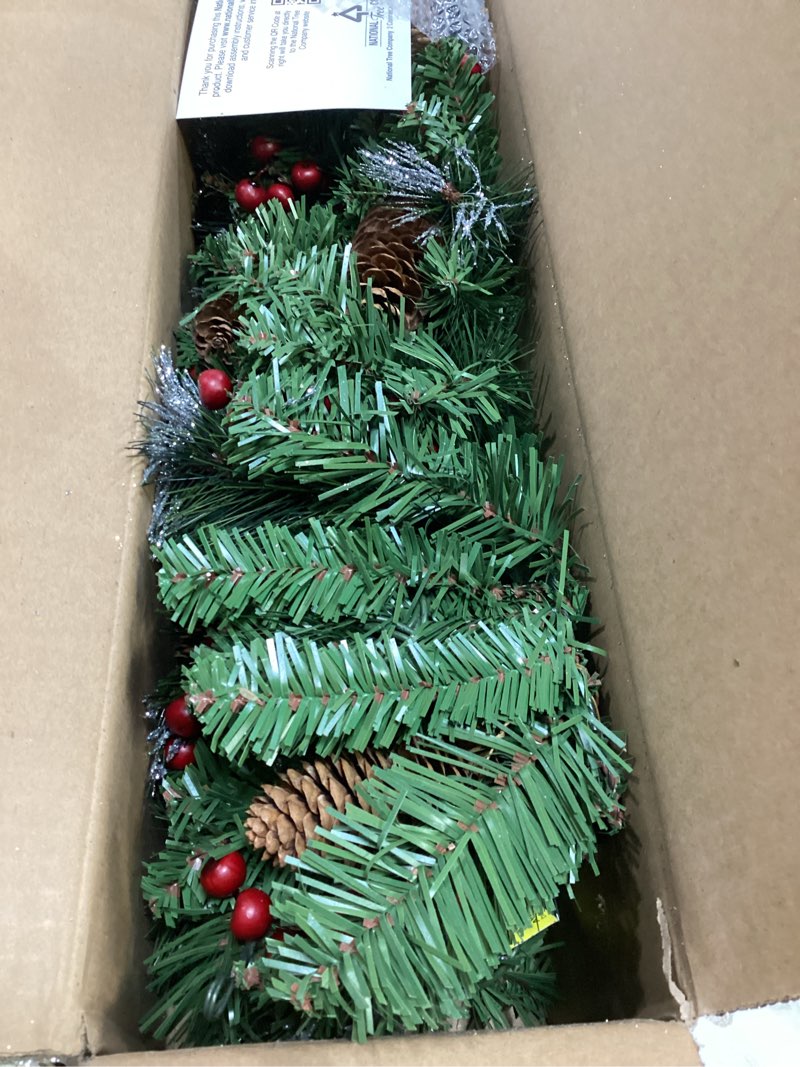 Condition photo showing Good Condition for national tree company 9 ft pre-lit crestwood spruce artificial christmas garland, christmas decoration with glitter, pinecones, red berries, 50 clear lights, 180 tips, green plug in tree