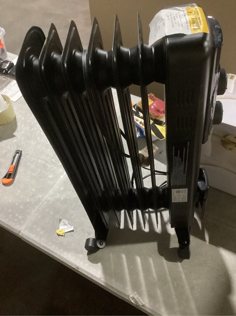 Condition photo showing As Is for utilitech 1500 -watt oil-filled radiant utility indoor electric space heater with thermostat