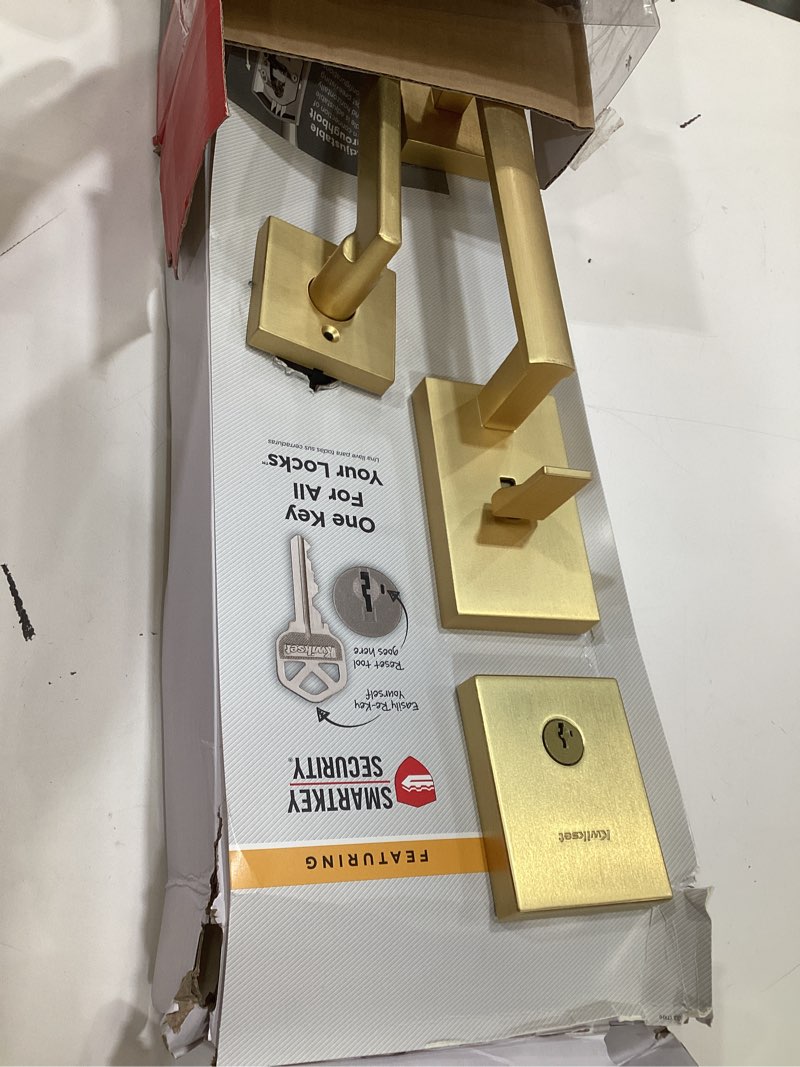 Condition photo showing As Is for kwikset san clemente front door lock handle and deadbolt set, entry handleset exterior with interior reversible lever, satin brass, pick resistant smartkey deadbolt security, with microban protection satin brass with handle keyed entry