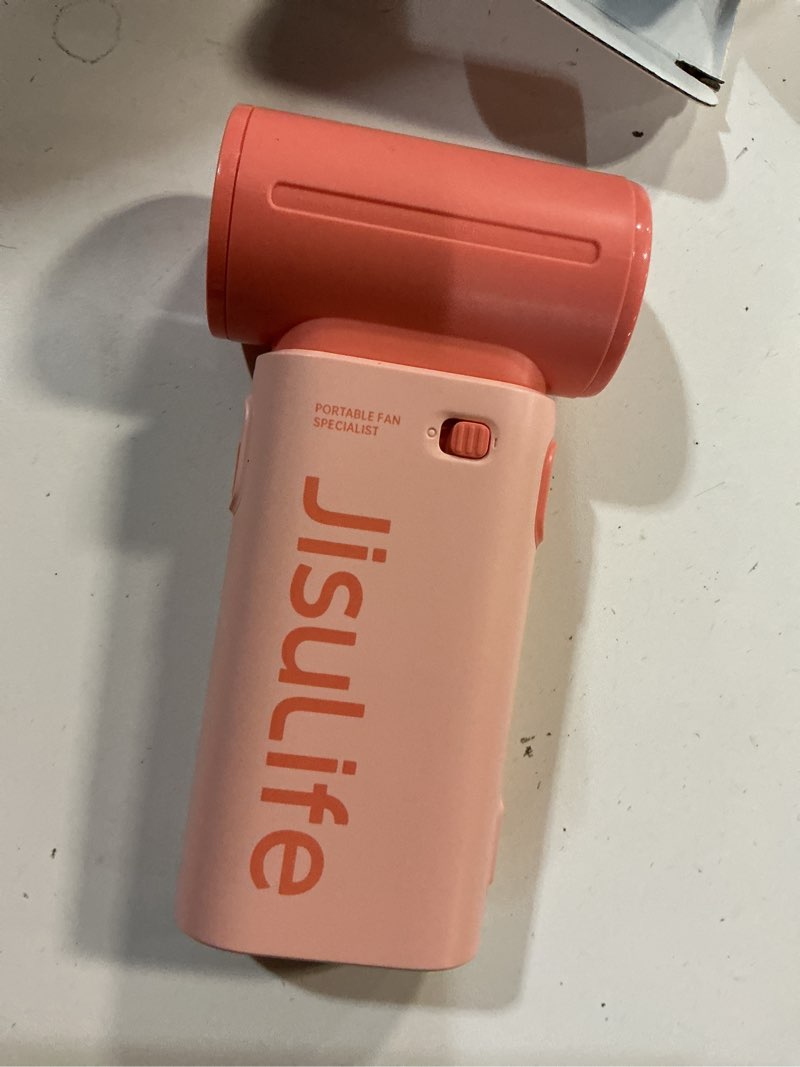 Condition photo showing As Is for jisulife portable handheld fan life9, turbo power high speed air [18h max cooling time], 5 gear wind, 5000mah rechargeable, mini pocket design, personal fan for travel concerts camping makeup - pink 5000mah pink