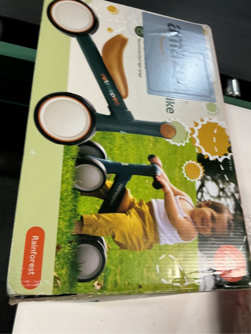 Condition photo showing New/Like New for Retrospec Cricket 2 Baby Walker Balance Bike with 4 Wheels - Safe Learning Toy for Ages 12-24 Months - Scratch-Resistant Indoor Outdoor Toddler Riding Toy with Steering Limit & Soft Grips Rainforest