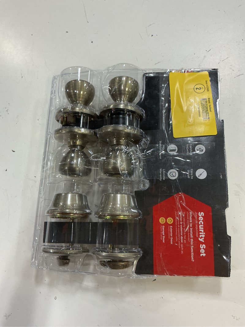 Condition photo showing As Is for tylo antique brass exterior entry door knob and single cylinder deadbolt project pack