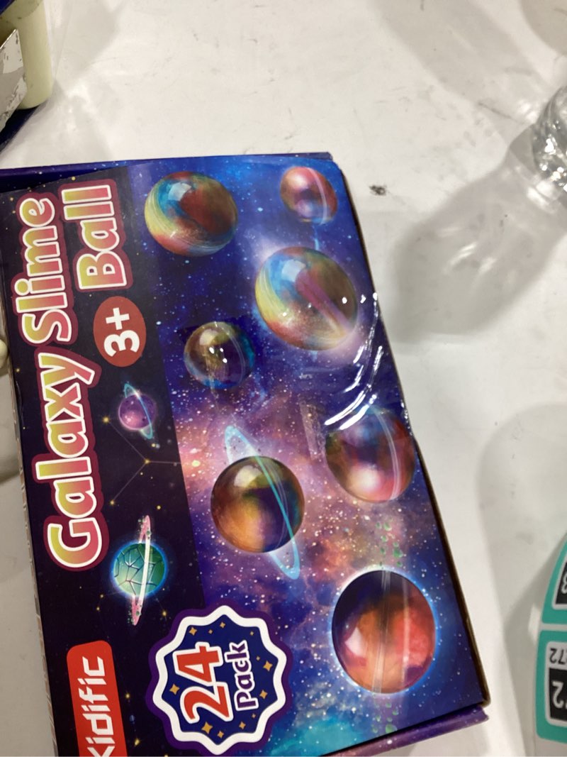 Condition photo showing Good Condition for 24 Pack Galaxy Slime Party Favors, Non-Sticky, Stress Relief Treasure Box Toys for Classroom Prizes, Easter Basket Stuffers Student Gifts Goodie Bags Egg Fillers for Kids Teens Boys Girls 4-8, 8-12