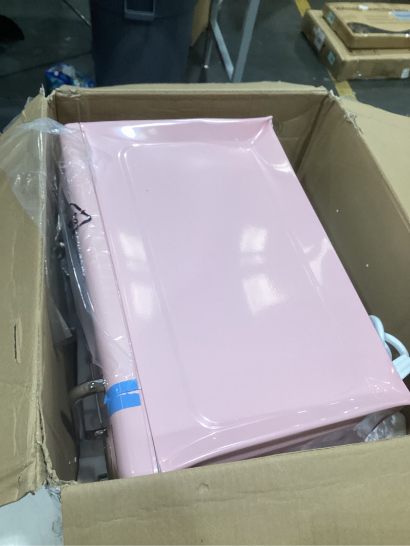 Condition photo showing As Is for nostalgia retro compact countertop microwave oven - 0.7 cu. ft. - 700-watts with led digital display - child lock - easy clean interior - pink retro classic 0.7 cu. ft. pink