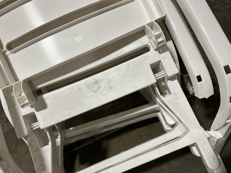 Condition photo showing As Is for 2 packstackable white plastic frame stationary chaise lounge chair(s) with slat seat