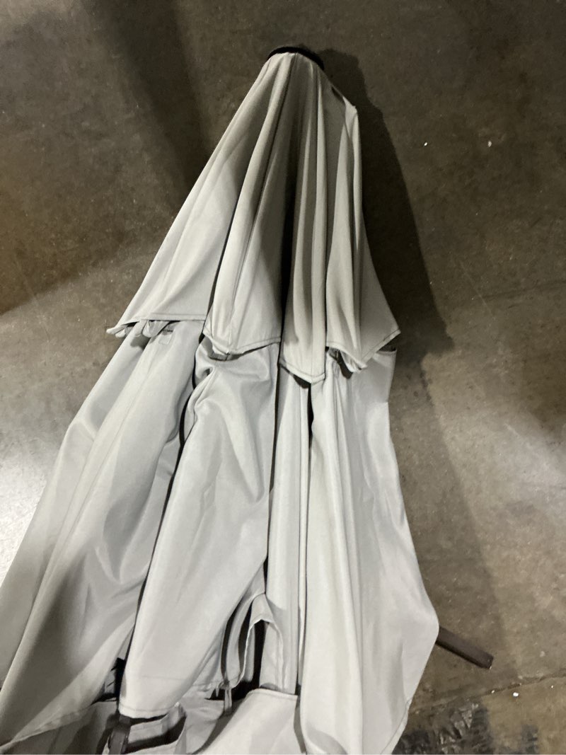 Condition photo showing As Is for 11-ft aluminum gray auto-tilt market patio umbrella