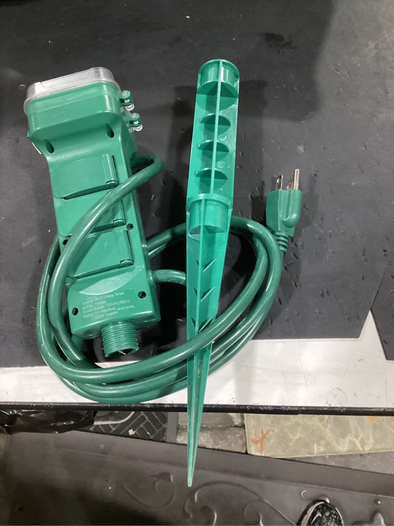 Condition photo showing As Is for (incomplete) suraielec outdoor power stake timer waterproof, 100ft wireless remote control, dusk to dawn timer, 6 grounded plug outlets, power strip for christmas lights, garden, patio, outdoor lights, 6ft 6 ft remote+photocell