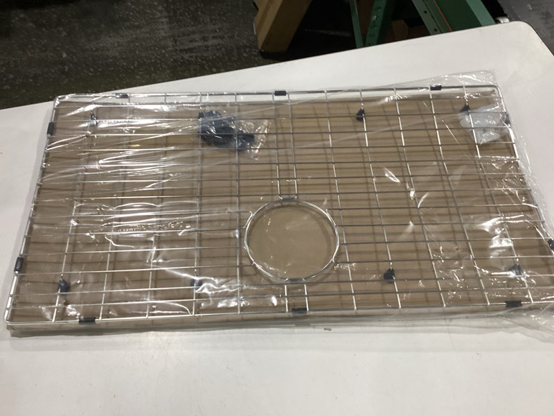 Condition photo showing New/Like New for 29.3 in. x 15.4 in. rear drain kitchen sink bottom grid with supersoft silicone feet in 304 grade stainless steel