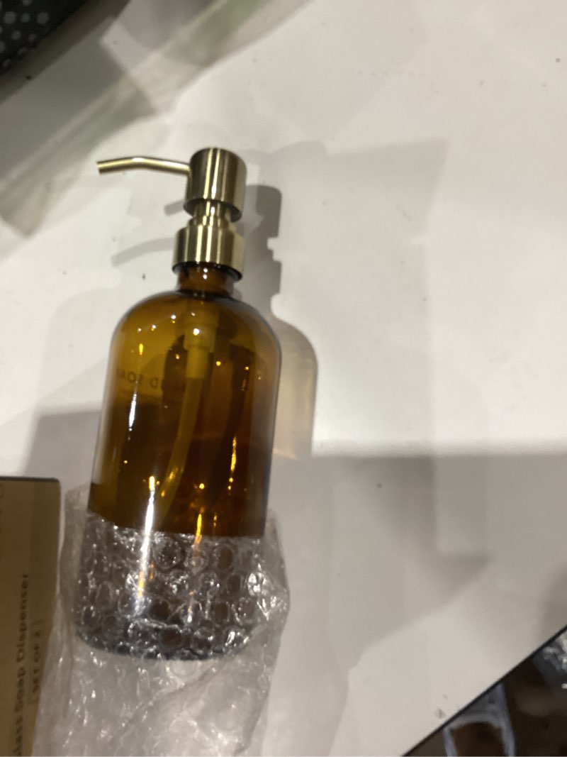 Condition photo showing Good Condition for vine creations amber glass soap dispenser set, dish soap and hand soap dispenser set with stainless steel pump, 16 oz glass dispensers for kitchen or bathroom decor (amber bottle/brushed brass pump) amber bottle / brushed brass pump