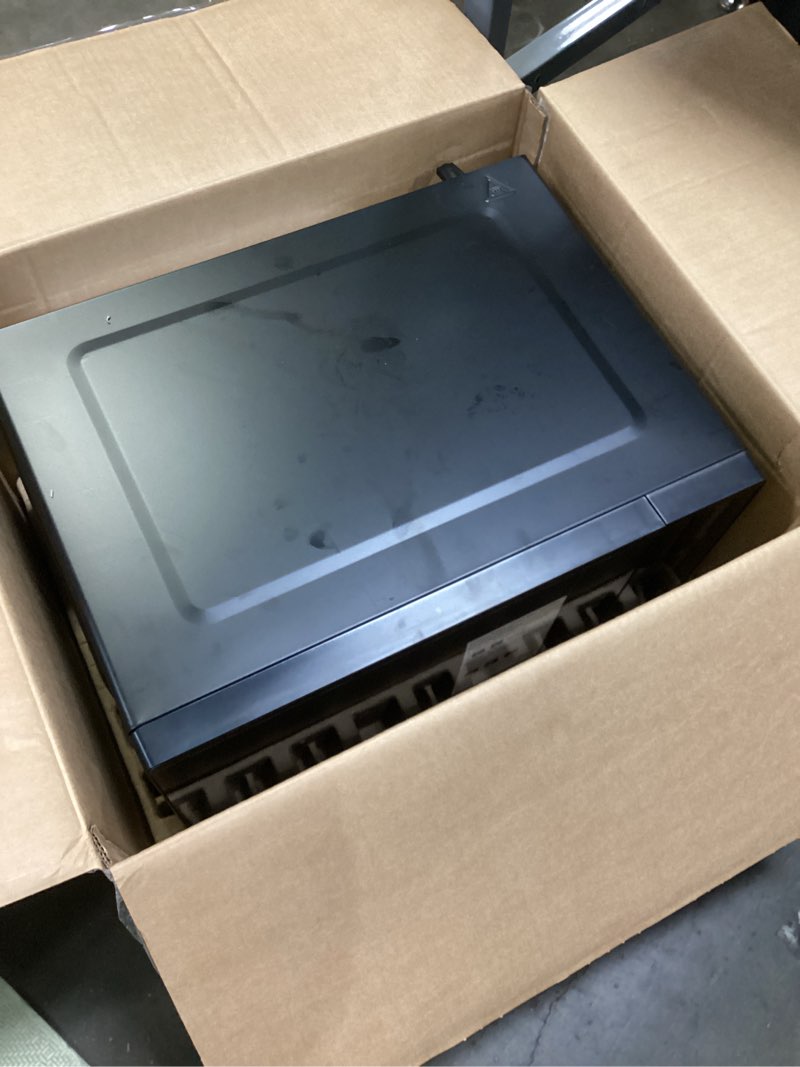 Condition photo showing As Is for mainstays 0.7 cu ft countertop microwave oven, 700 watts, black, new