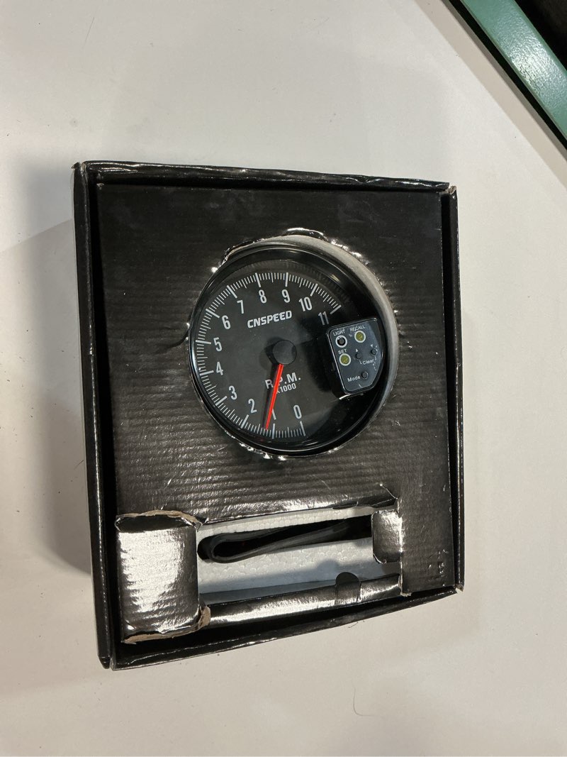 Condition photo showing As Is for 12v 5in car tachometer with led shift light 7 color display 11 rpm clear lens installation package for 4 6 8 cylinder vehicles