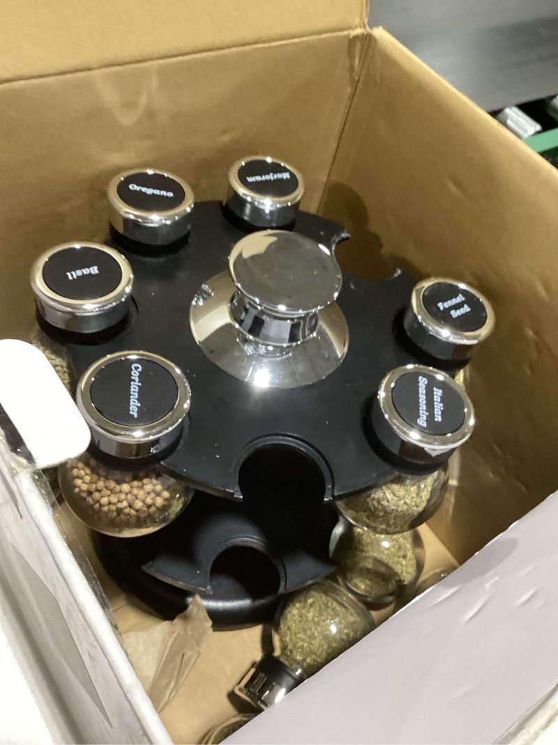 Condition photo showing As Is for Kamenstein 16 Jar Ellington Revolving Countertop Spice Rack with Lift & Pour Caps and Spices Included, FREE Spice Refills for 5 Years: Black and Chrome