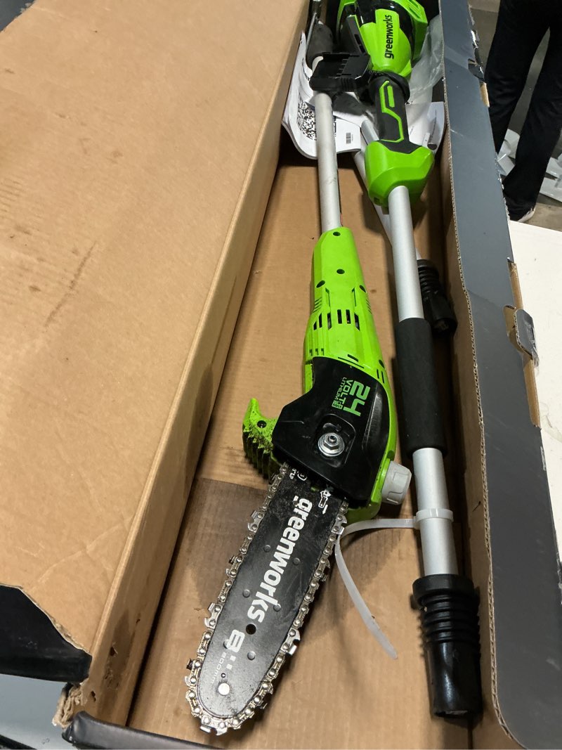 Condition photo showing As Is for greenworks 24v 8" cordless polesaw (great for pruning and trimming branches / 125+ compatible tools), 2.0ah battery and charger included 8" polesaw (2.0ah)
